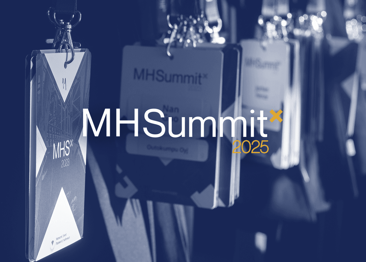 The logo of the Metalshub Summit 2025 over a darkened background of name tags