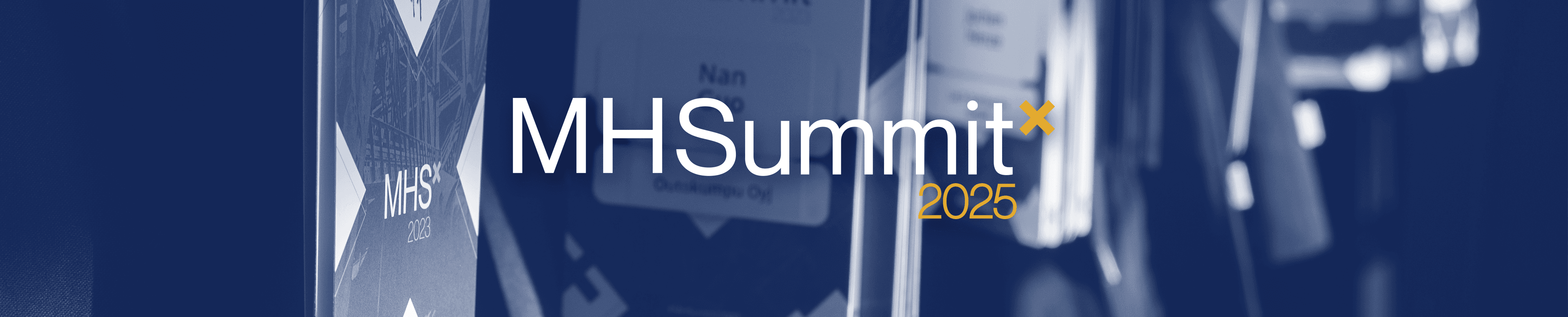 The logo of the Metalshub Summit 2025 over a darkened background of name tags