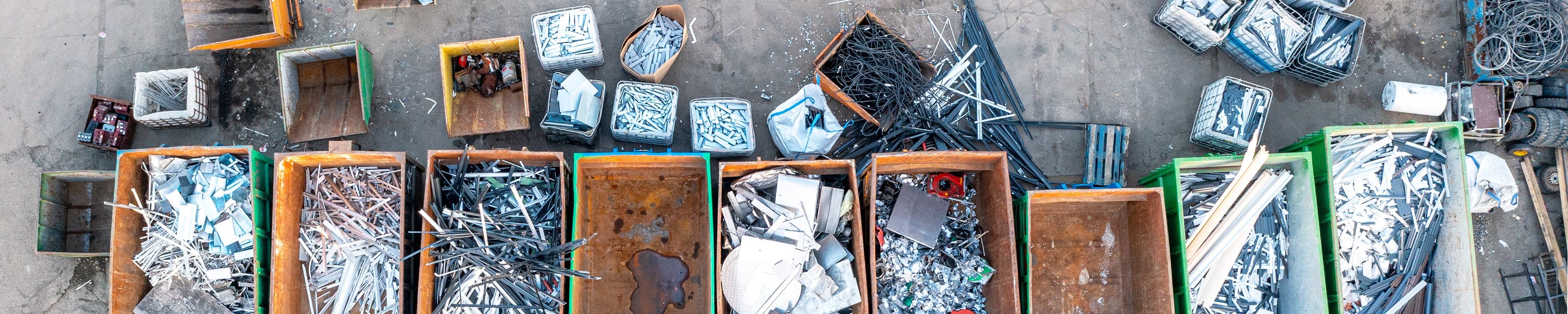 Scrap metals in different containers seen from a top view