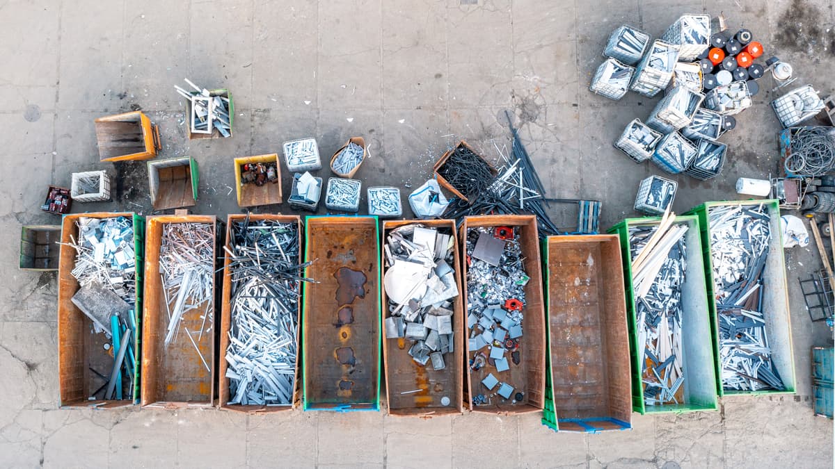 Scrap metals in different containers seen from a top view