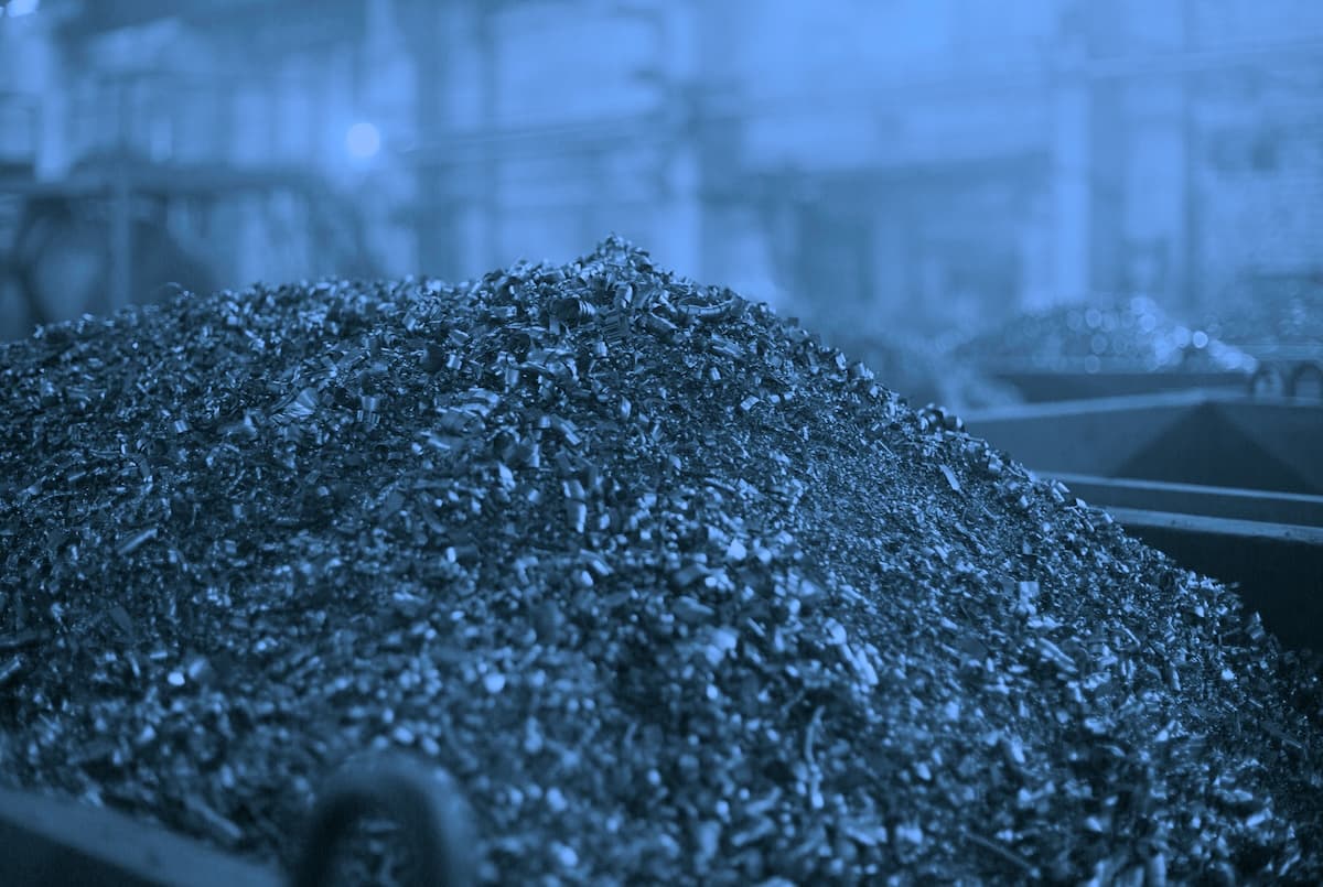 Darkened image of shredded scrap raw materials in a factory