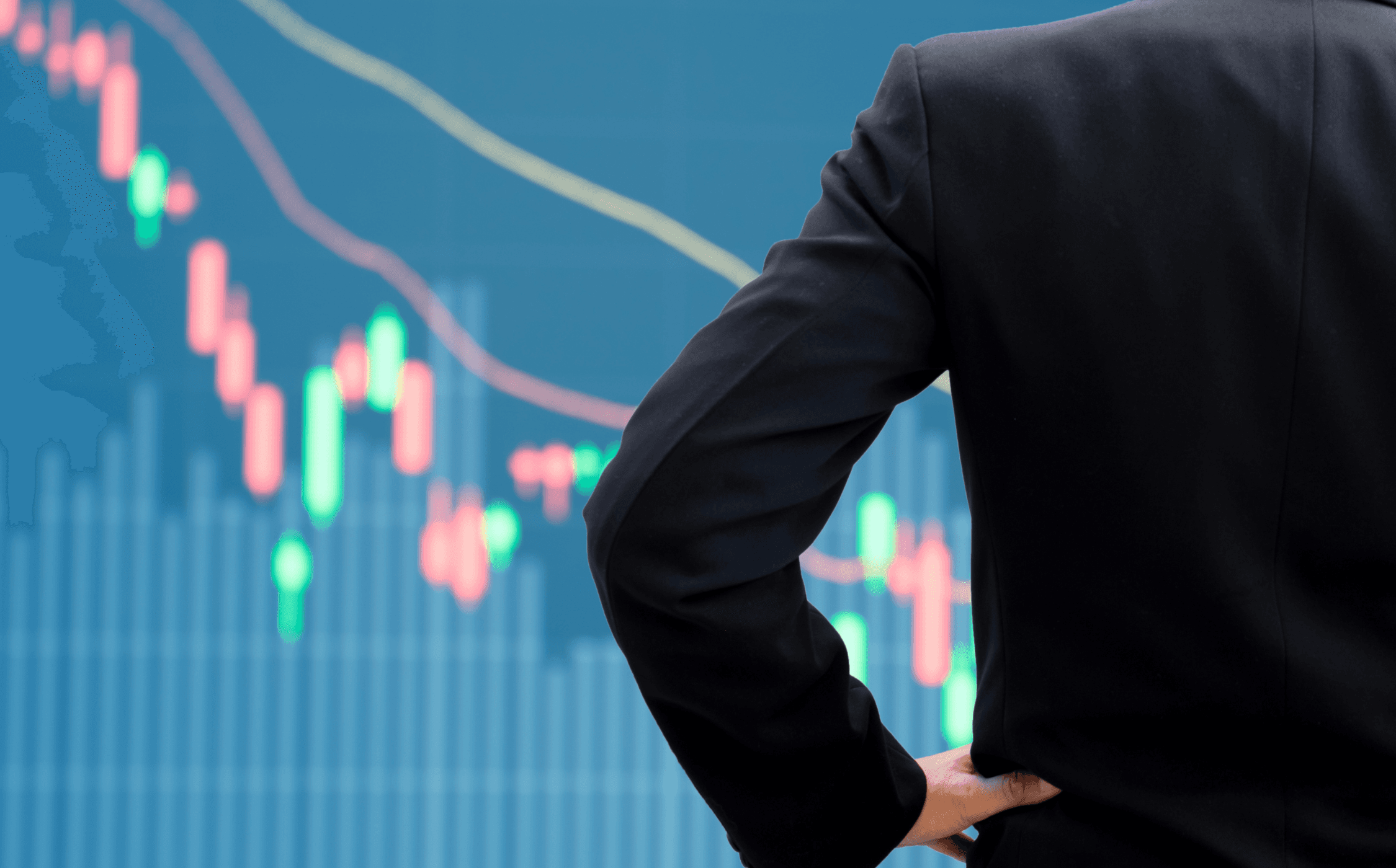 Image of a man standing in front of market trading data
