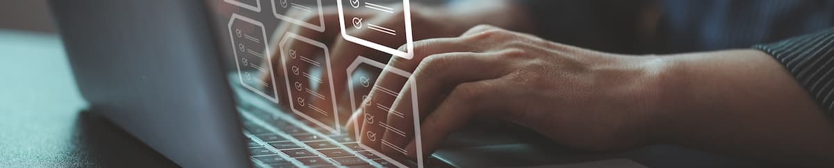 Person typing on a laptop with graphics of documents and completed tasks showing in the space in front of the screen