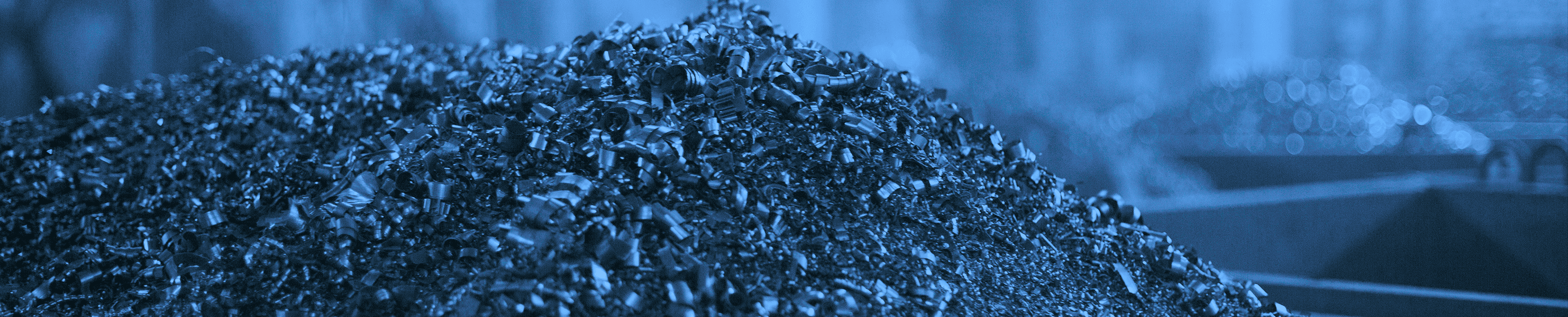 Darkened image of shredded scrap raw materials in a factory