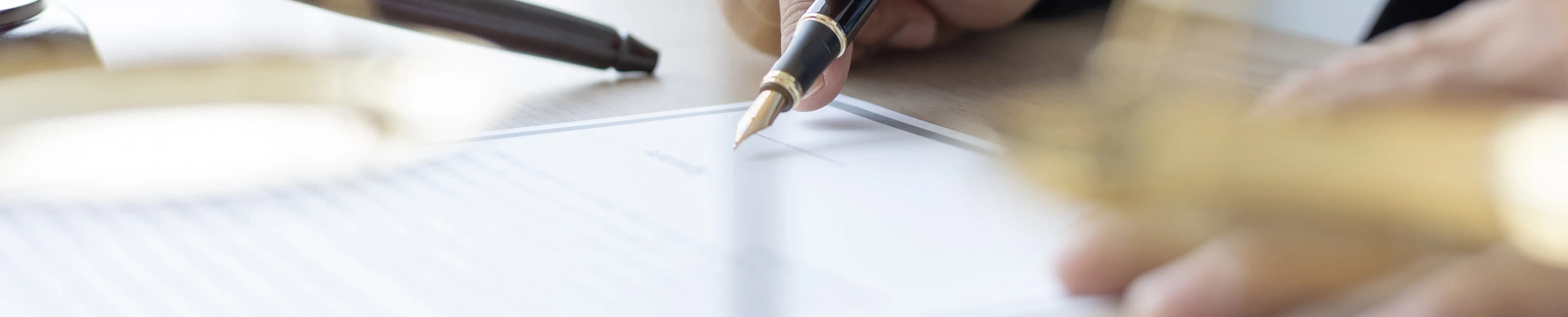 A close up shot of a pen over a business document